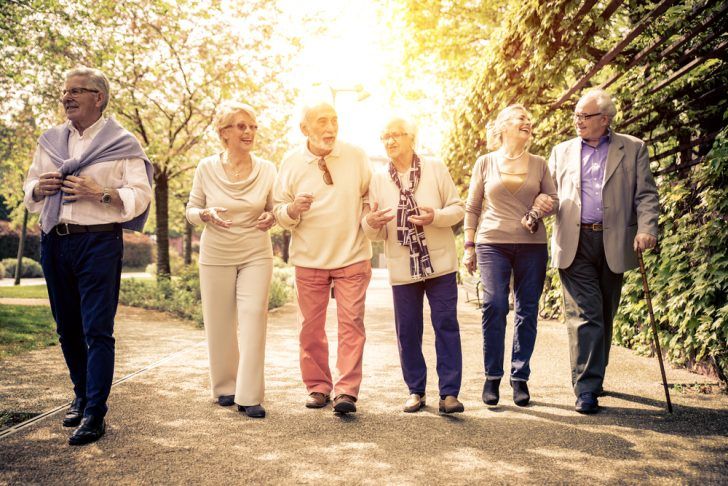 Senior citizens enjoying a walk on a sunny afternoon