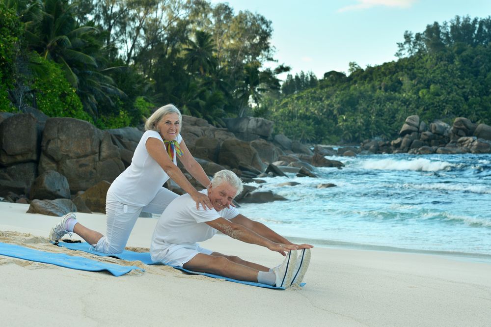 Senior couple exercising on the beach