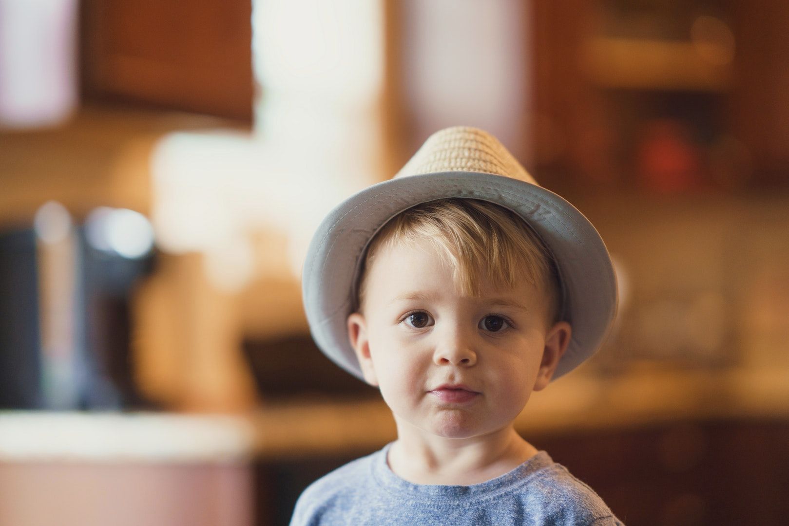 Cute little blond boy wearing t-shirt and hat